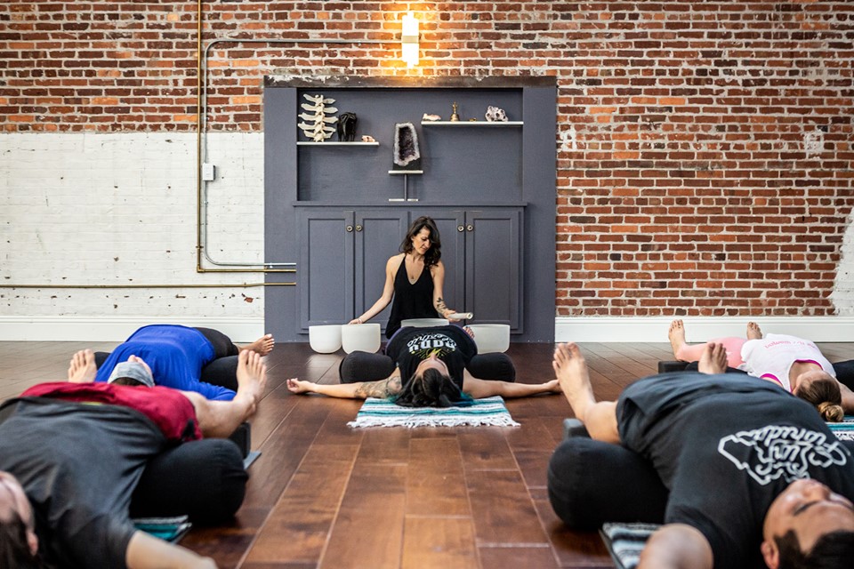 A yoga teacher with students